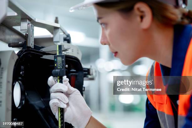 digital caliper as a modern solution for accurate measurements in the manufacturing process. close-up shot of a quality control engineer use a digital caliper to measure the gap tolerance of sample auto parts for confirm quality. - calliper stock pictures, royalty-free photos & images