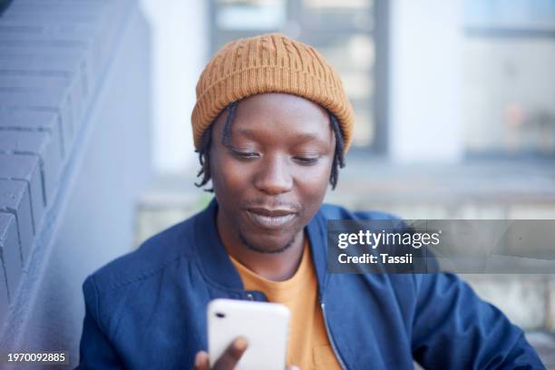 phone, steps or black man on social media for news or reading information on internet outdoors. chat, post or african student on stairs networking online for communication or texting on mobile app - weekend update stock pictures, royalty-free photos & images