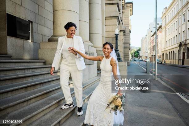 lgbtqia couple celebrating their love with an elopement wedding in the city. - wedding ceremony city hall stock pictures, royalty-free photos & images