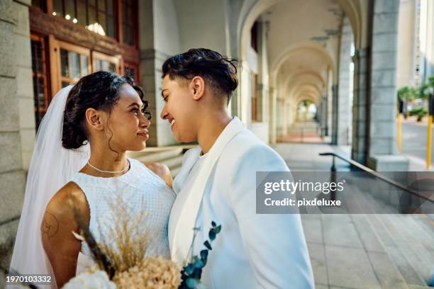 lgbtqia couple celebrating their love with an elopement wedding in the city. - wedding ceremony city hall stock pictures, royalty-free photos & images