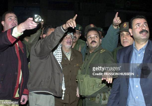 Palestinian Authority President Yasser Arafat flanked by bodyguards, including his personal guard Mohammed al-Dayeh and office manager Ramzi Khoury,...