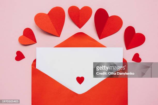 empty valentine card with red envelope and paper hearts on pink backgrount - red card envelope stock pictures, royalty-free photos & images