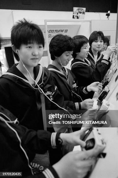 Junior High-School students try walkmans in a Sony showroom on April 25, 1986 in Ginza. Sony is a Japanese multinational founded in 1946 by...