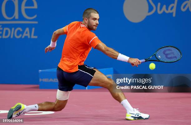 Croatia's Borna Coric returns the ball to Spain's Pedro Martinez during their singles tennis match at the Open Sud de France ATP World Tour in...