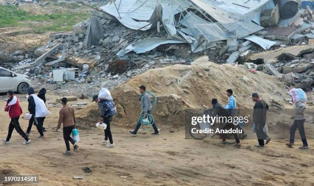 Hours after the Israeli army withdrew from the region, residents are seen arriving amid destruction to check their homes and properties that they had...