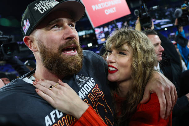 Travis Kelce of the Kansas City Chiefs celebrates with Taylor Swift after defeating the Baltimore Ravens in the AFC Championship Game at M&T Bank...