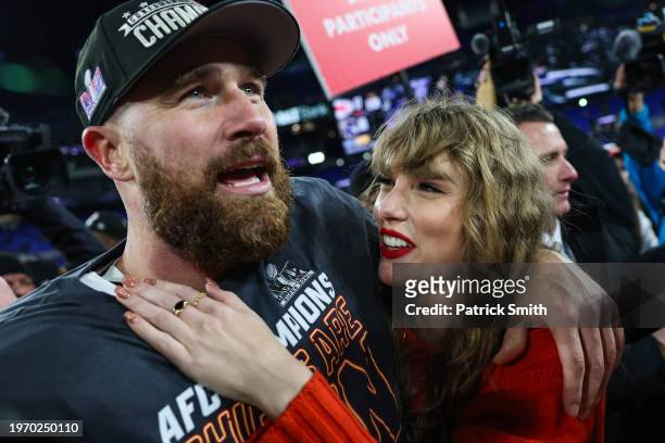 Travis Kelce of the Kansas City Chiefs celebrates with Taylor Swift after defeating the Baltimore Ravens in the AFC Championship Game at M&T Bank...