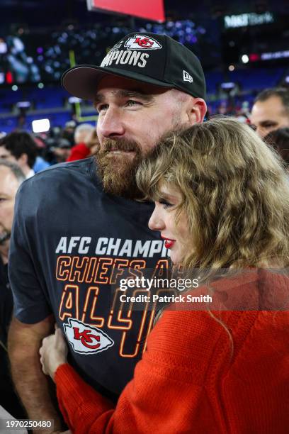 Travis Kelce of the Kansas City Chiefs celebrates with Taylor Swift after defeating the Baltimore Ravens in the AFC Championship Game at M&T Bank...