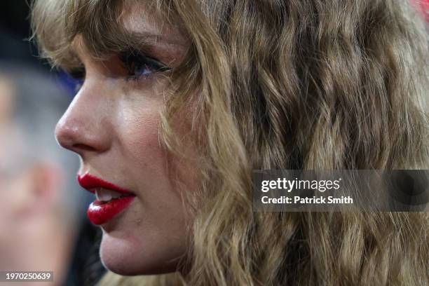 Travis Kelce of the Kansas City Chiefs celebrates with Taylor Swift after defeating the Baltimore Ravens in the AFC Championship Game at M&T Bank...