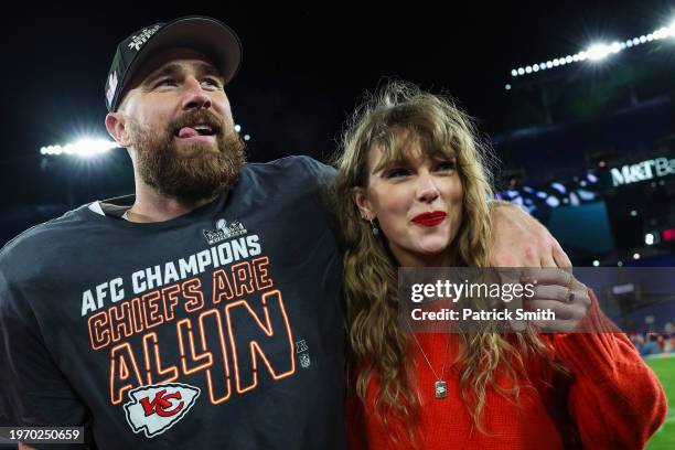 Travis Kelce of the Kansas City Chiefs celebrates with Taylor Swift after defeating the Baltimore Ravens in the AFC Championship Game at M&T Bank...