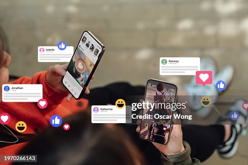 Closeup of two friends commenting and giving likes on social media platform via smartphone Closeup of two friends commenting and giving likes on social media platform via smartphone