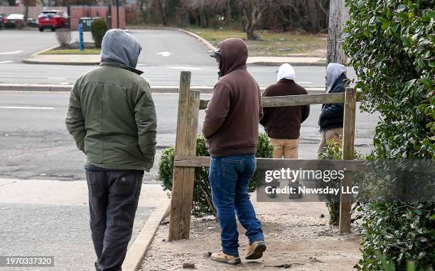 In hopes of getting picked up for jobs, day laborers gather at a gas station on the corner of Horseblock Road and North Ocean Avenue in Farmingville,...