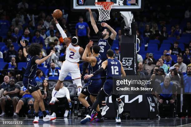 Josh Okogie of the Phoenix Suns goes up for a shot against Goga Bitadze of the Orlando Magic during the fourth quarter at Kia Center on January 28,...