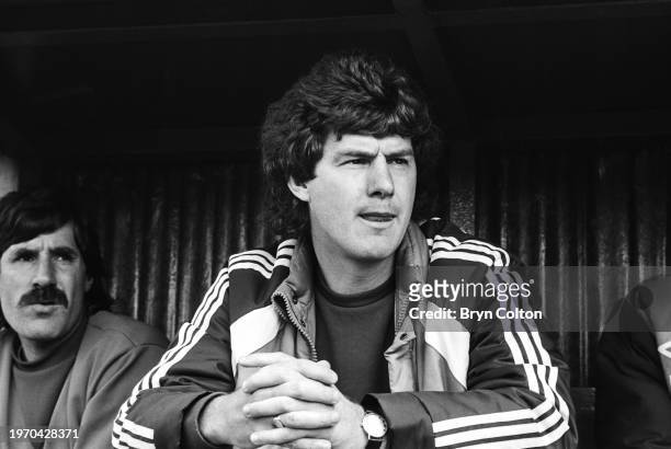 Brian Kidd, manager of Preston North End football club, sits in the coaches dugout during a game at Deepdale Stadium in Preston, Lancashire, UK, on...