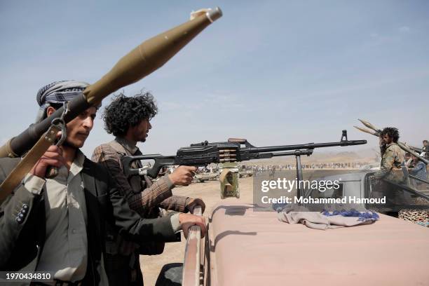 Yemen's Houthi fighters man machine gun and RPG mounted on vehicles while participating in a weaponized rally and parade against the America-Britain...