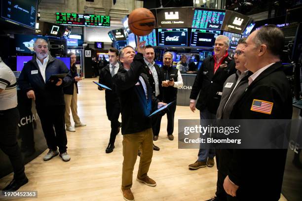 Trader plays with a basketball during the Amer Sports Inc. Initial public offering on the floor of the New York Stock Exchange in New York, US, on...