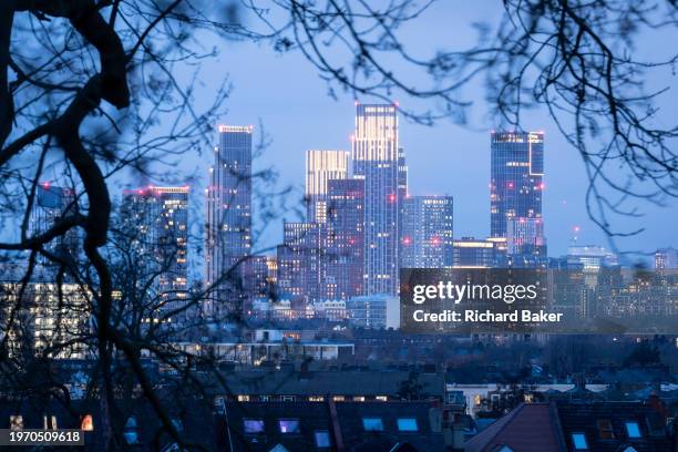 Seen through the branches of trees in Lambeth's Ruskin Park is the growing development at Nine Elms, on 31st January 2024, in London, England.