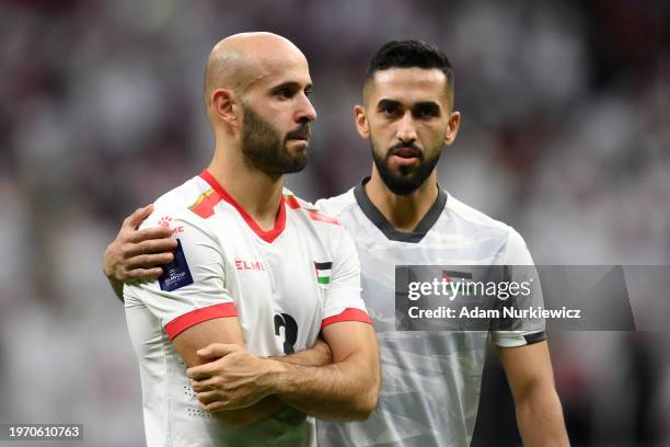 Mohammed Rashid of Palestine is consoled after the team's defeat in the AFC Asian Cup Round of 16 match between Qatar and Palestine at Al Bayt...