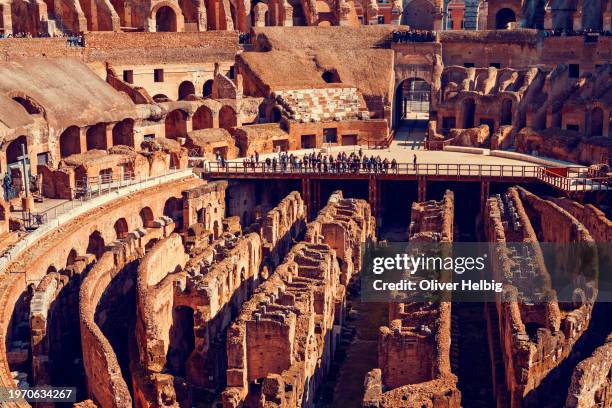 the inside of the colosseum in rome with a large number of tourists - rome empire stock pictures, royalty-free photos & images