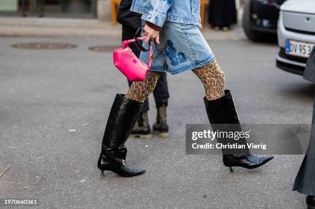 Guest wears pink bag, black knee high boots outside Nicklas Skovgaard during the Copenhagen Fashion Week AW24 on January 29, 2024 in Copenhagen,...