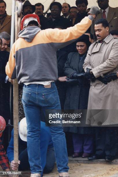 Coretta Scott King and Dexter Scott King watch as workers lower a time capsule containing highlights of the life of Martin Luther King Jr. Into the...