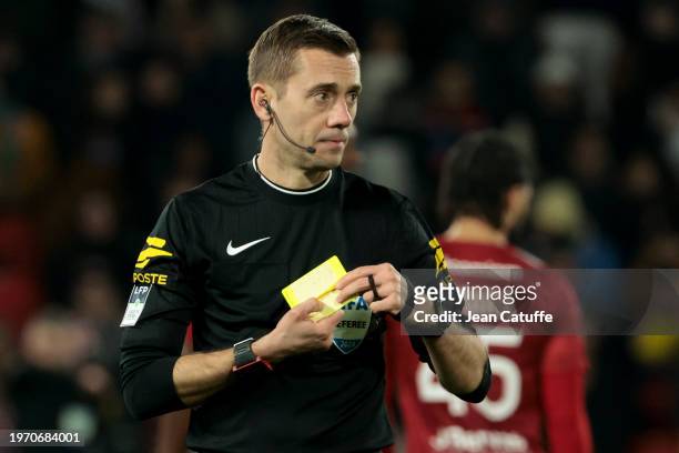 Referee Clement Turpin gives a yellow card during the Ligue 1 Uber Eats match between Paris Saint-Germain and Stade Brestois 29 at Parc des Princes...