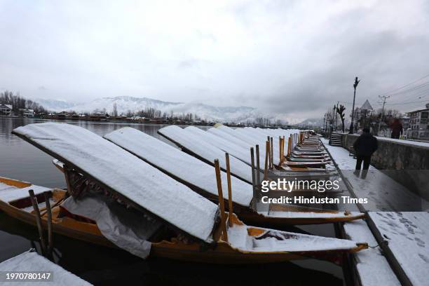 View of snow covered boats at Dal Lake after a season's first snowfall on February 1, 2024 in Srinagar, India. It is the season's first snowfall in...