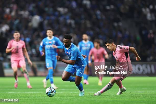 Khalifah Al-Dawsari of Al Hilal battles for possession with Luis Suarez of Inter Miami during the Riyadh Season Cup match between Al Hilal and Inter...