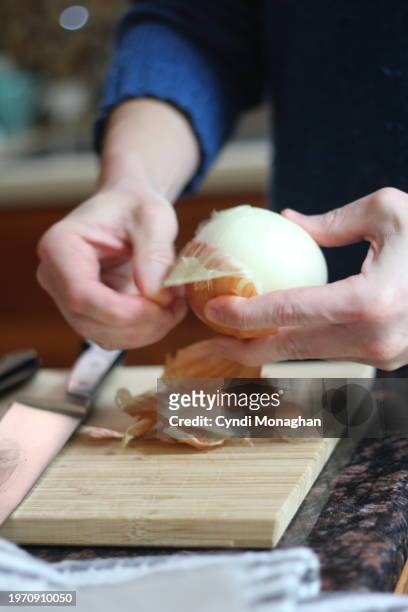 man peeling and cutting an onion - service of thanksgiving stock pictures, royalty-free photos & images