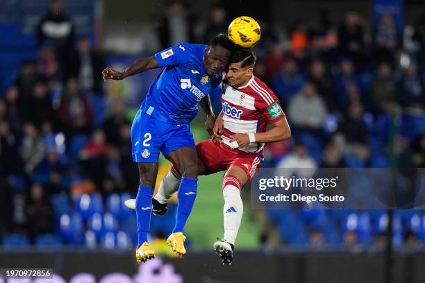 Djene Dakonam of Getafe CF battle for the ball with Matias Arezo of Granada CF during the LaLiga EA Sports match between Getafe CF and Granada CF at...