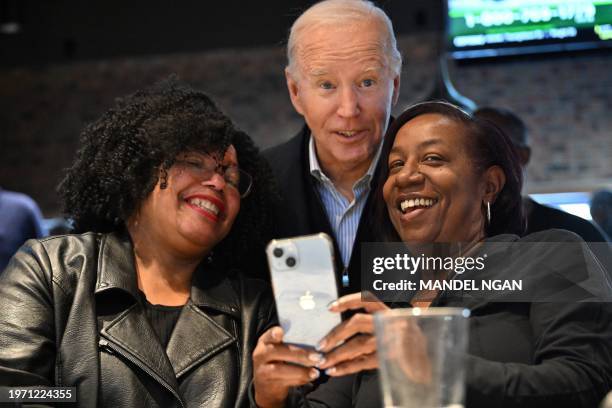 President Joe Biden poses for selfies with patrons at They Say restaurant in Harper Woods, Michigan, on February 1, 2024.