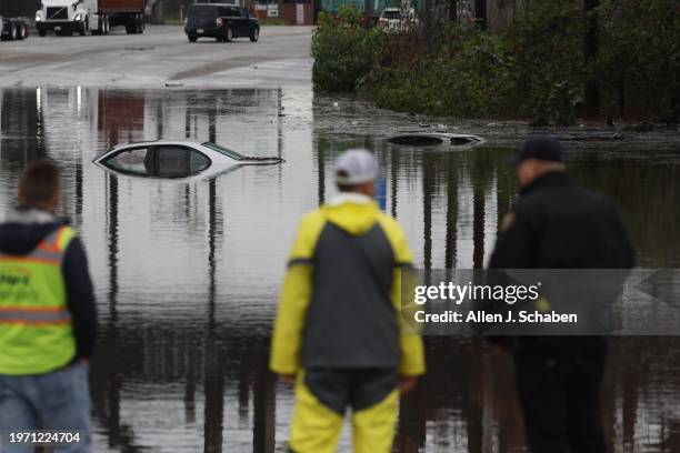 Cars are submerged in the 2300 block of W. Willow Street in Long Beach Thursday morning, February 1 as the first of a pair of storms brought...