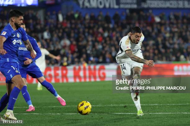 Real Madrid's Spanish forward Joselu scores his team's second goal during the Spanish league football match between Getafe CF and Real Madrid CF at...