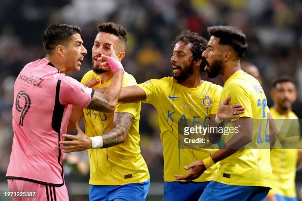Inter Miami's Uruguayan forward Luis Suarez argues with Nassr's Saudi defender Nawaf Boushal and Saudi midfielder Abdulmajeed al-Sulayhem during the...
