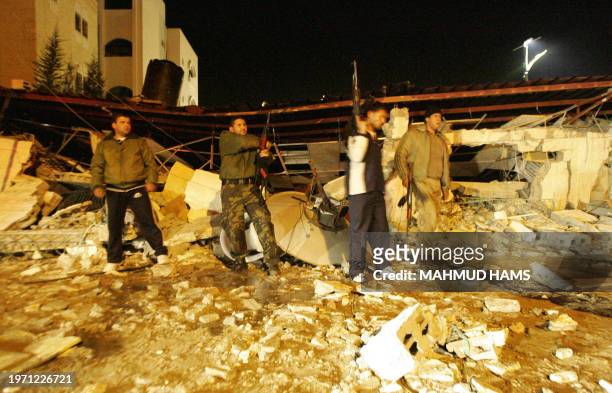 Palestinians gather around the debris of al-Shams club after an Israeli helicopter attack in Gaza City 05 February 2006. Three members of the Al-Aqsa...