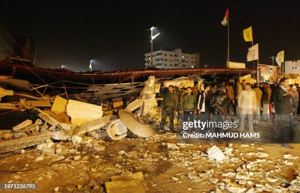 Palestinians gather around the debris of al-Shams club after an Israeli helicopter attack in Gaza City 05 February 2006. Three members of the Al-Aqsa...