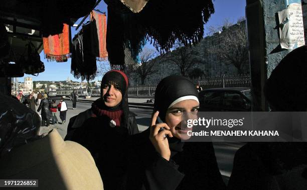 Palestinians walk in an East Jerusalem street 19 January 2006. More than half Israeli Jews would be willing to re-divide Jerusalem and hand over the...
