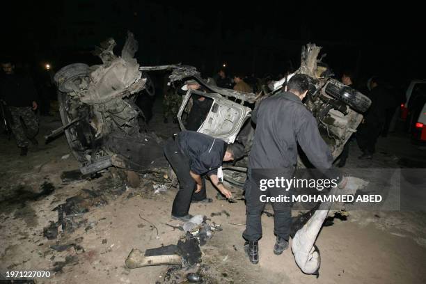 Palestinian police check debris of a car after an Israeli helicopter attack in Gaza City 05 February 2006. Three members of the Al-Aqsa Martyrs'...