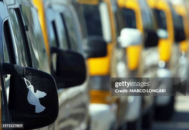 Cabs line up on the Gaza City waterfront 07 August 2005. A local taxi company registered 160 cars and drivers in order to provide transportation for...