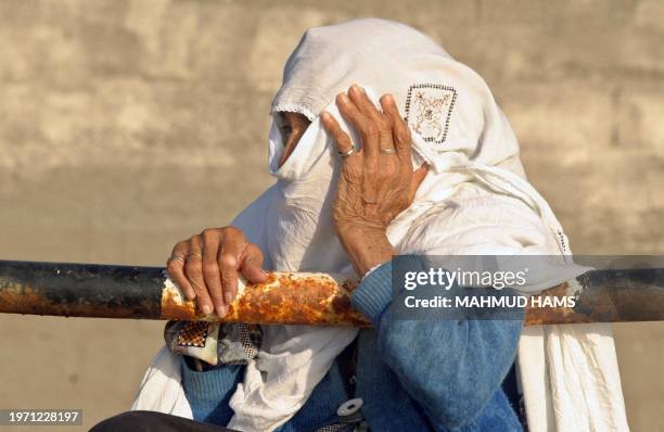 An old woman watches the sunset at Gaza City's Shati refugee camp 13 May 2005. Tomorrow Israel is celebrating the 57th anniversary of its creation...