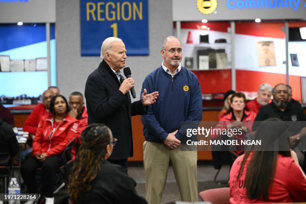 President Joe Biden speaks alongside UAW president Shawn Fain during a visit to a United Auto Workers phone bank in the metropolitan Detroit area,...