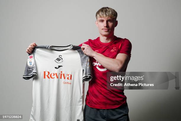 Przemyslaw Placheta poses for a picture with a home shirt after signing a contract with Swansea City AFC at Fairwood Training Ground on February 1,...
