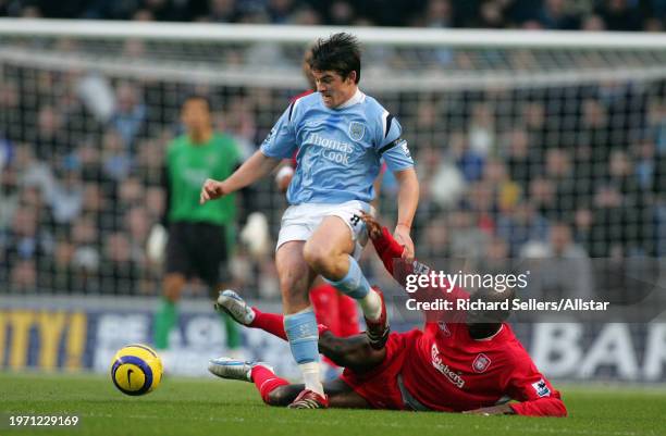 November 26: Joey Barton of Manchester City and Momo Sissoko of Liverpool challenge during the Premier League match between Manchester City and...