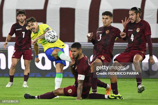 Brazil's forward Mauricio stikes the ball over Venezuela's defender Carlos Vivas , defender Rafel Uzcategui, and defender Andres Ferro during the...