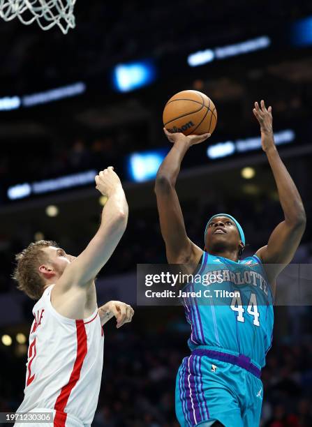 Frank Ntilikina of the Charlotte Hornets attempts a shot over Jock Landale of the Houston Rockets during the second half of the game at Spectrum...