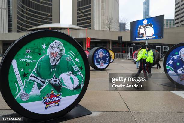 Giant hockey pucks with pictures of 2024 NHL All-Star players are seen ahead of 2024 NHL All-Star Weekend festivities at the Nathan Phillips Square...