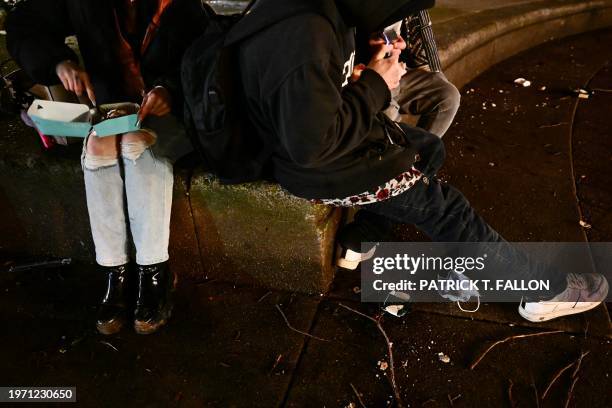 "Jae" eats a Cinnabon cinnamon roll while her boyfriend and another person prepare to use fentanyl following the decriminalization of all drugs in...