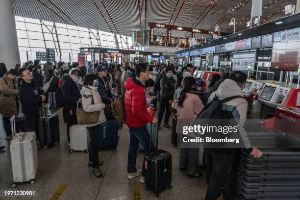 Travelers at Beijing Capitol Airport in Beijing, China, on Thursday, Feb. 1, 2024. China is gearing up for a record number of trips during Lunar New...