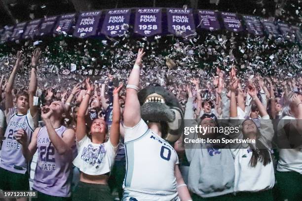 Kansas State Wildcats mascot Willie the Wildcat and students throw newspaper shreds into the air as Final Four banners hang above them before a Big...