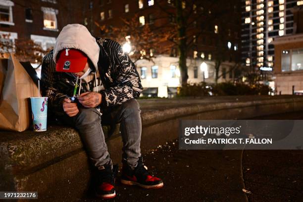 Person is using fentanyl on Park Avenue following the decriminalisation of all drugs in downtown Portland, Oregon on January 23, 2024. Since hard...